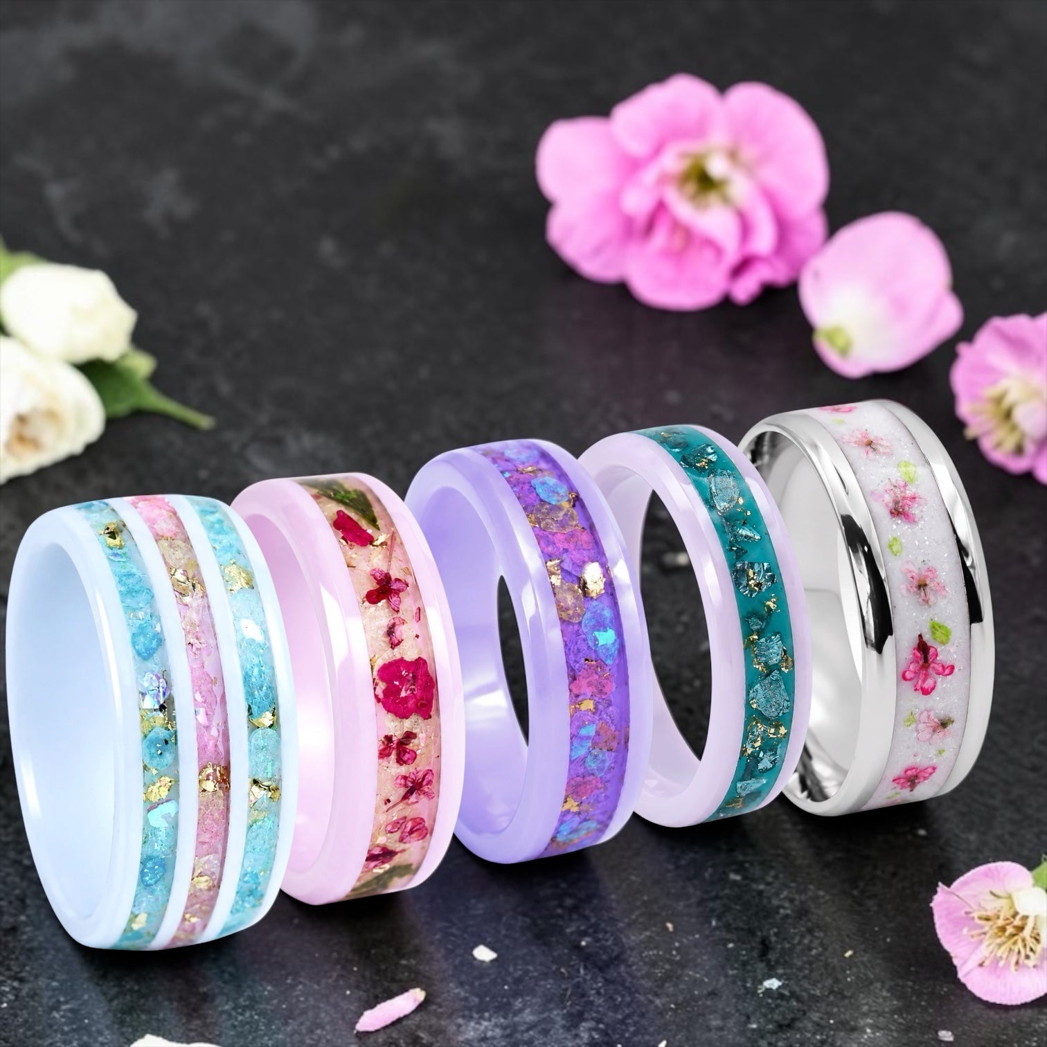 Handcrafted romantic rings featuring pressed flowers, soft pastel colors, and sparkling accents.