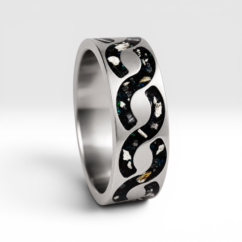 Abyssforge titanium ring featuring Megalodon tooth fragments, Campo del Cielo meteorite shavings, Mount Etna lava stone, green opal accents, and a sculpted flowing pattern.