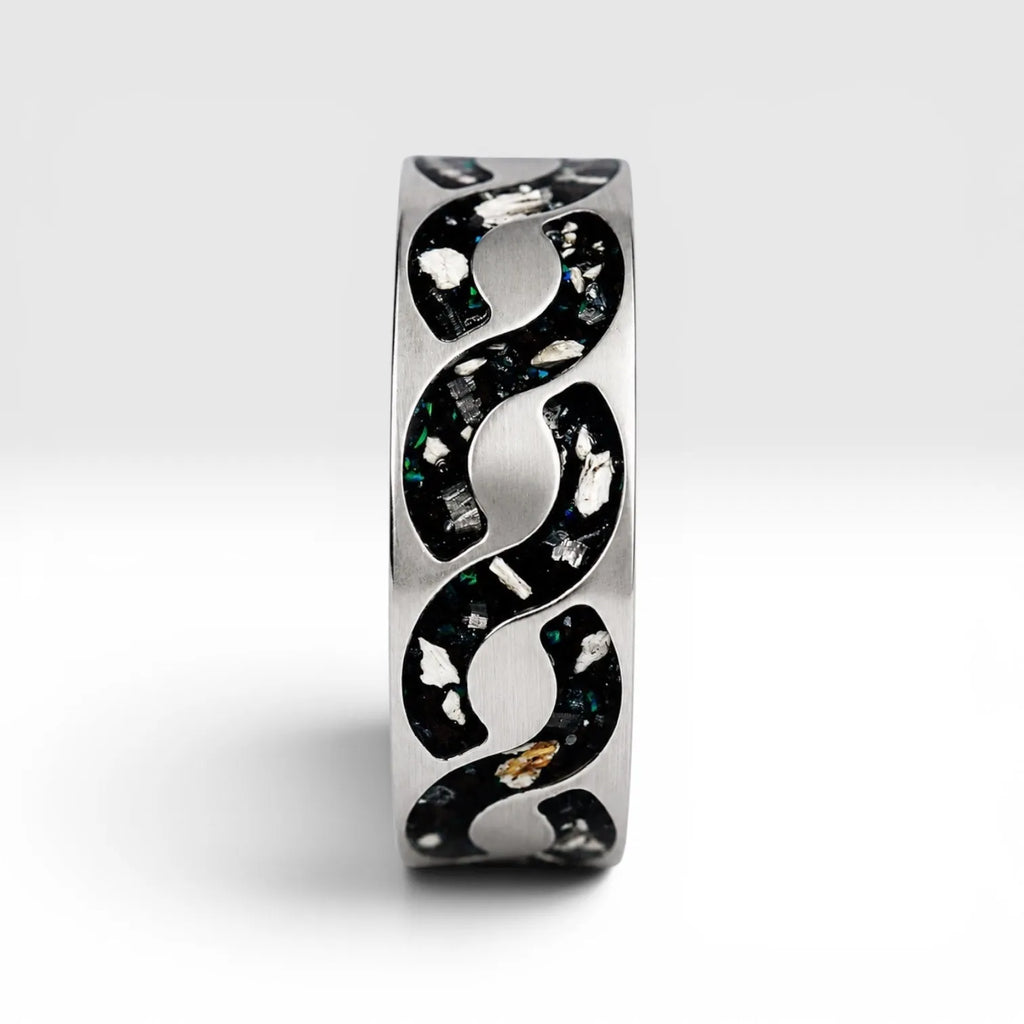 Abyssforge titanium ring featuring Megalodon tooth fragments, Campo del Cielo meteorite shavings, Mount Etna lava stone, green opal accents, and a sculpted flowing pattern.
