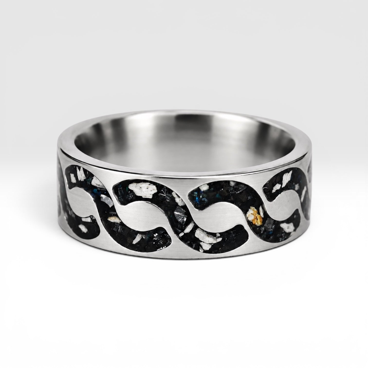Abyssforge titanium ring featuring Megalodon tooth fragments, Campo del Cielo meteorite shavings, Mount Etna lava stone, green opal accents, and a sculpted flowing pattern.