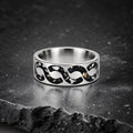 Abyssforge titanium ring featuring Megalodon tooth fragments, Campo del Cielo meteorite shavings, Mount Etna lava stone, green opal accents, and a sculpted flowing pattern.