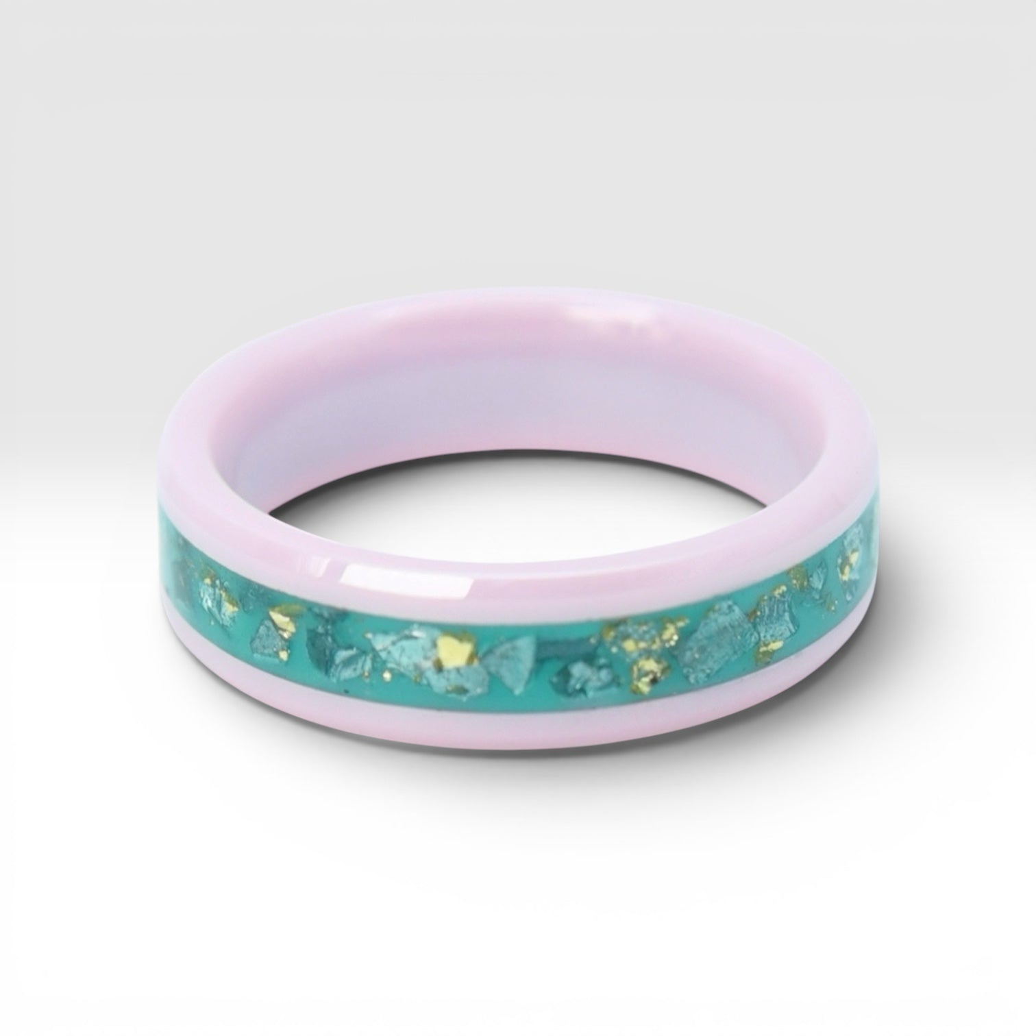 Pink ceramic ring with teal sea glass and gold leaf inlay, smooth polished band with ocean inspired design