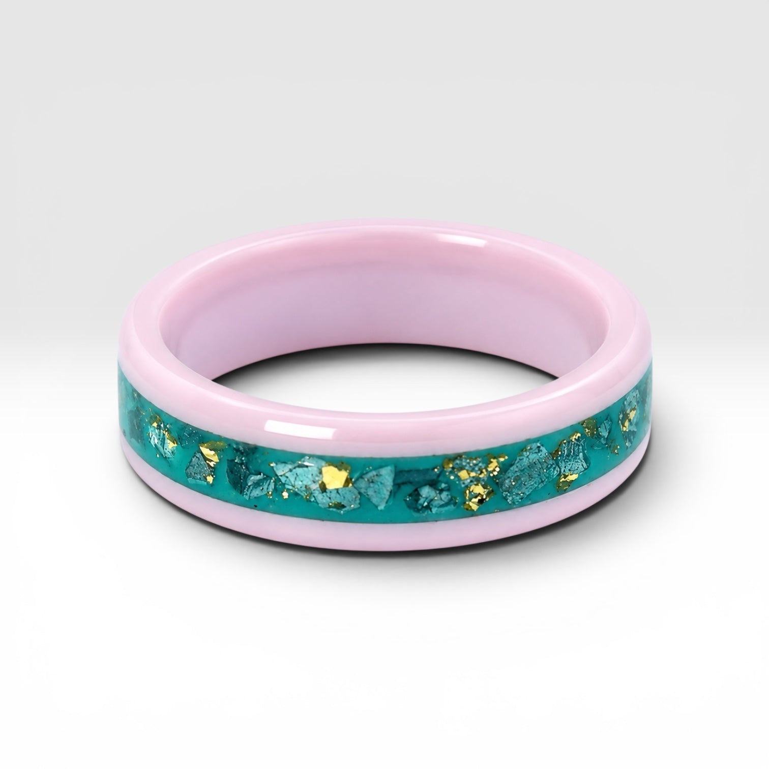 Pink ceramic ring with teal sea glass and gold leaf inlay, smooth polished band with ocean inspired design