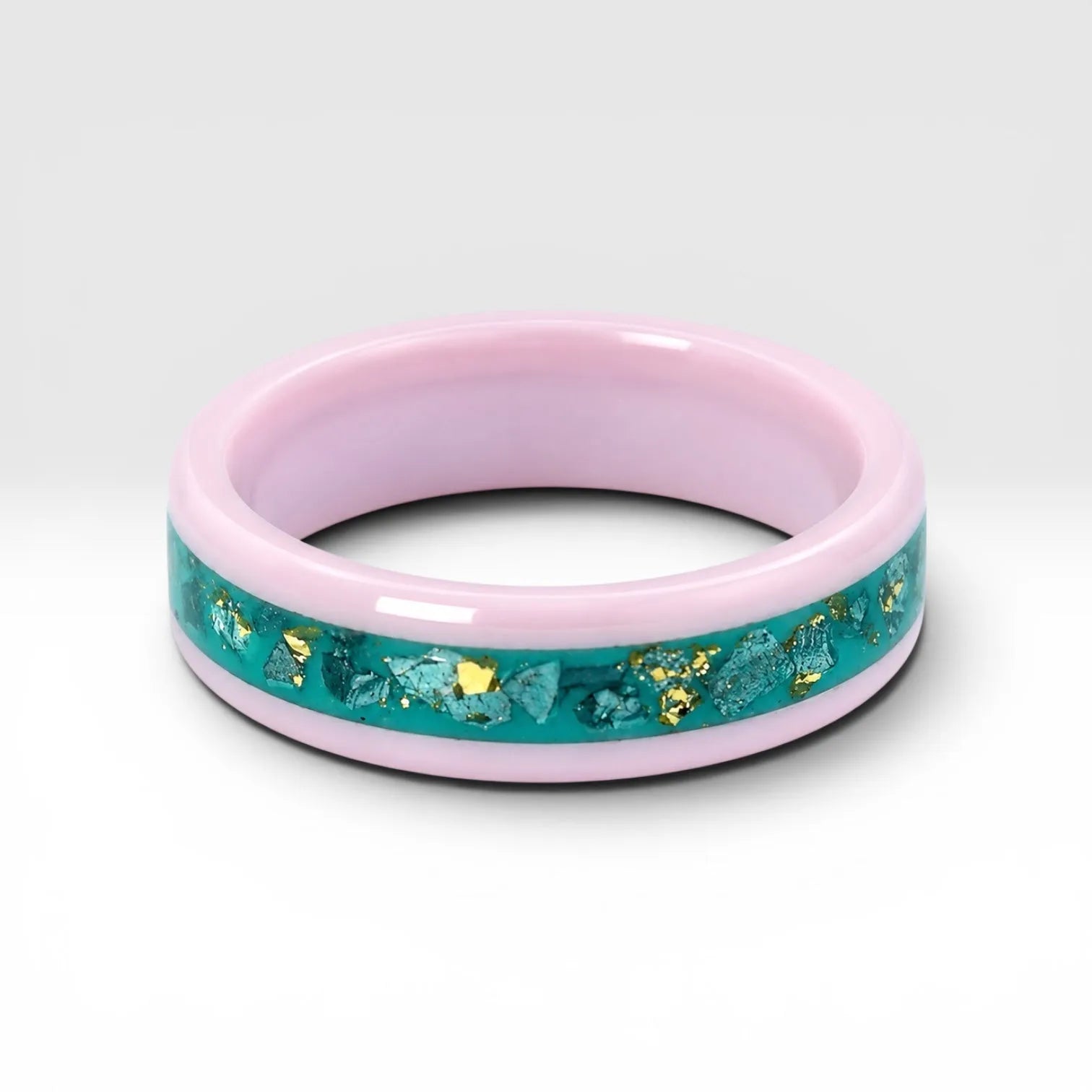 Pink ceramic ring with teal sea glass and gold leaf inlay, smooth polished band with ocean inspired design