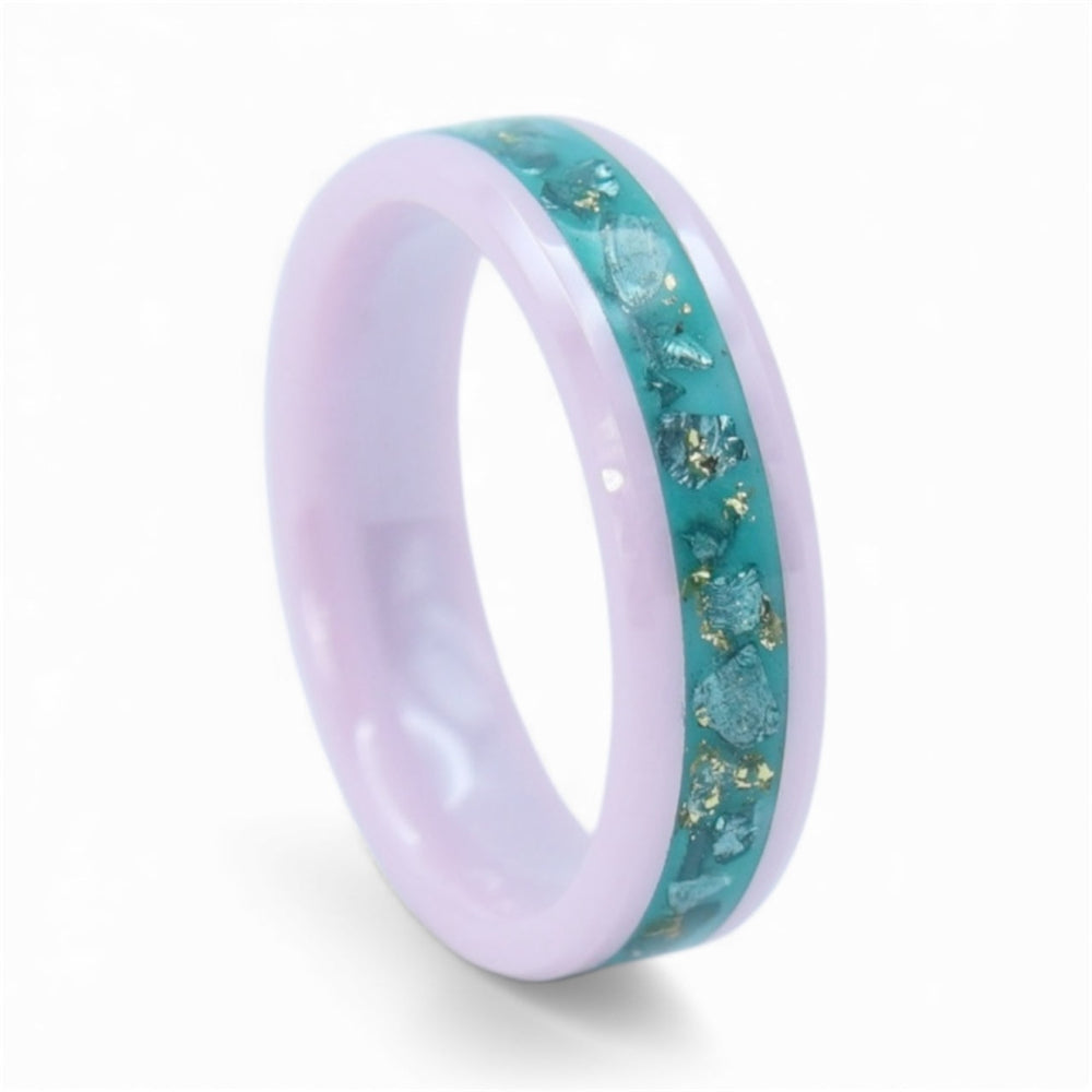 Close-up of pink ceramic ring with teal sea glass and gold leaf showing textured ocean inspired inlay