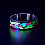 Arcadia titanium ring featuring a colorful abstract inlay with multi-color glow-in-the-dark elements inspired by retro arcade aesthetics.