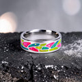 Arcadia titanium ring featuring a colorful abstract inlay with multi-color glow-in-the-dark elements inspired by retro arcade aesthetics.