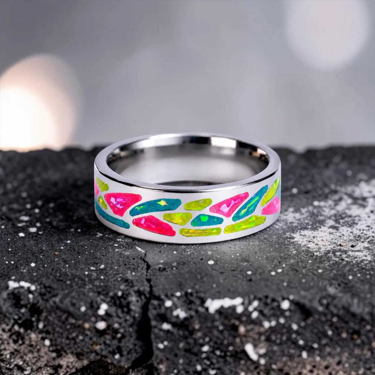 Arcadia titanium ring featuring a colorful abstract inlay with multi-color glow-in-the-dark elements inspired by retro arcade aesthetics.