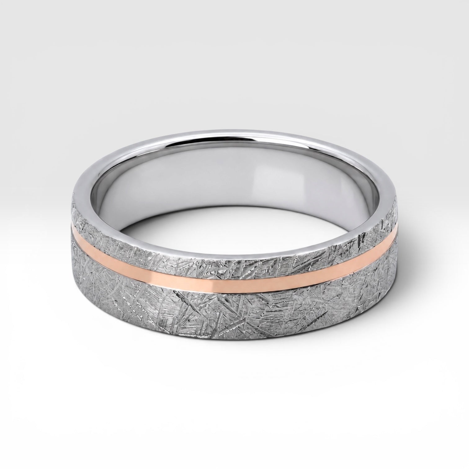 Sterling silver ring with rose gold offset inlay and meteorite texture, minimalist handcrafted wedding band