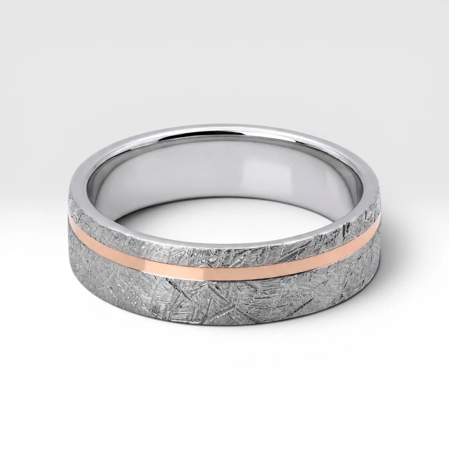 Sterling silver ring with rose gold offset inlay and meteorite texture, minimalist handcrafted wedding band