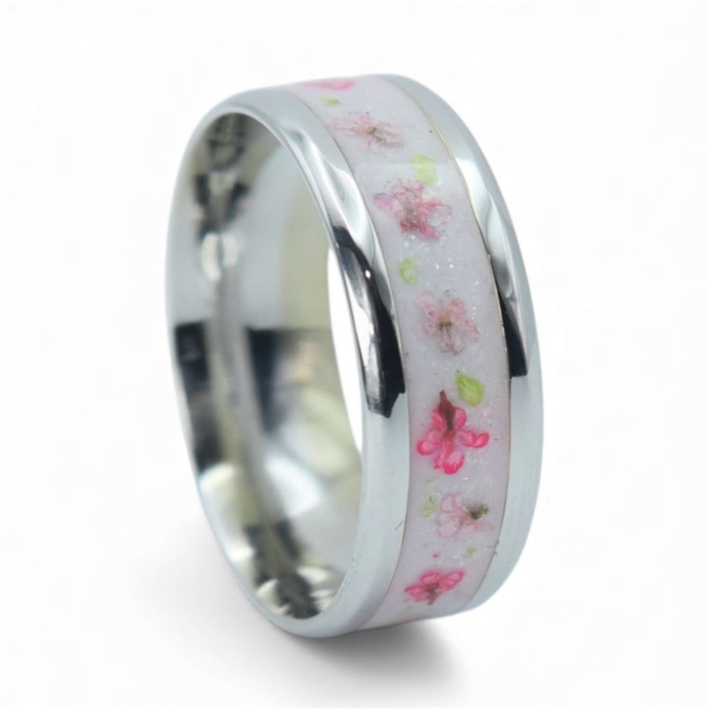 Close-up of cobalt ring with real pressed flowers set in shimmering background showing delicate floral detail