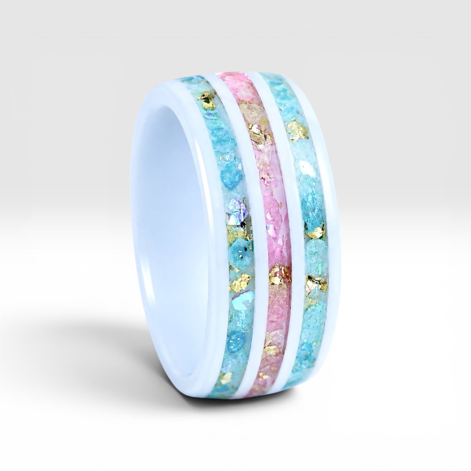 Bloomstripe white ceramic ring featuring three floral inlay channels with real flower petals, iridescent accents, and gold leaf details.