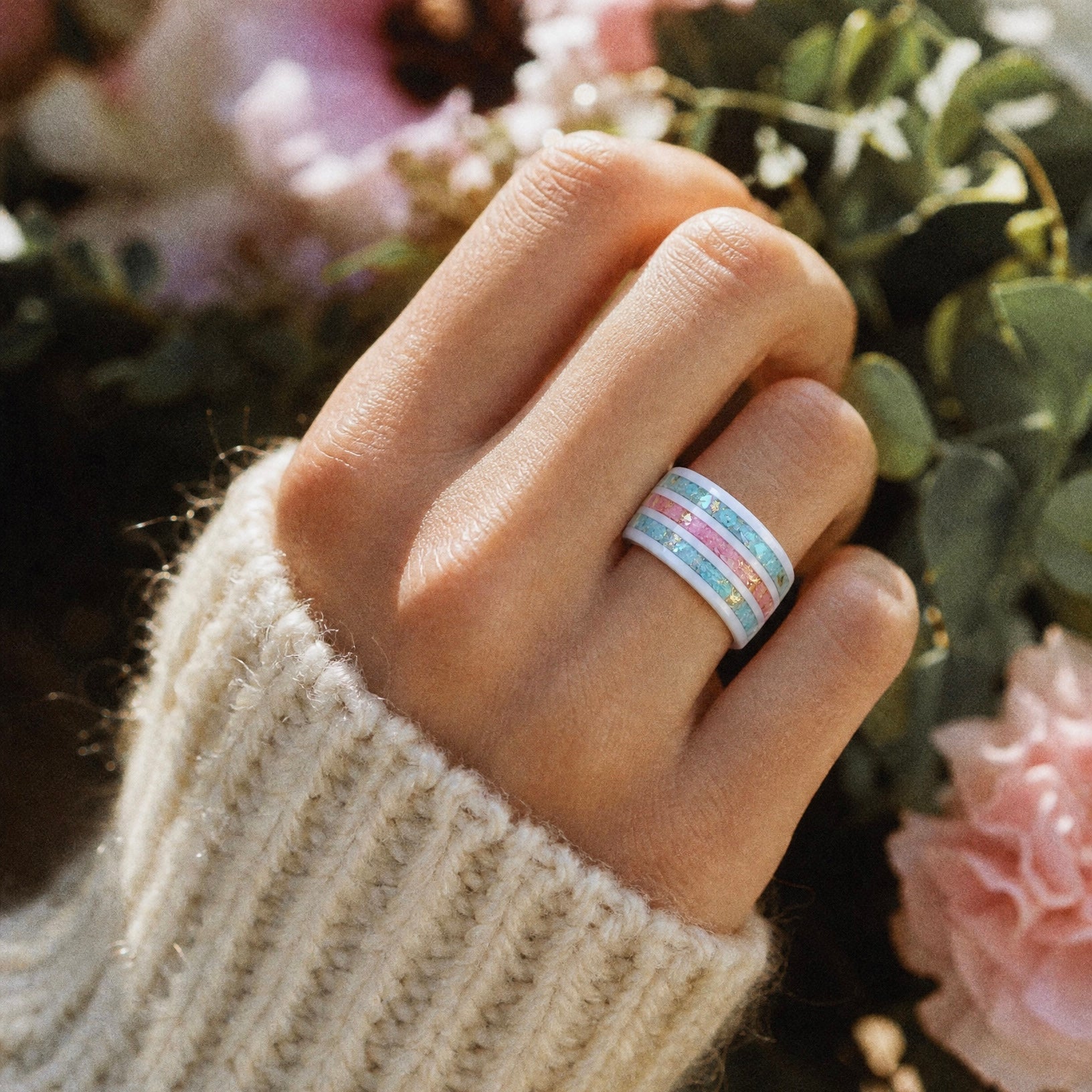 Bloomstripe white ceramic ring featuring three floral inlay channels with real flower petals, iridescent accents, and gold leaf details.
