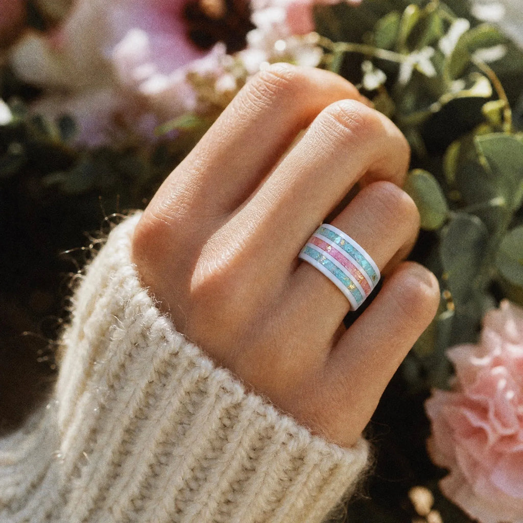 Bloomstripe white ceramic ring featuring three floral inlay channels with real flower petals, iridescent accents, and gold leaf details.