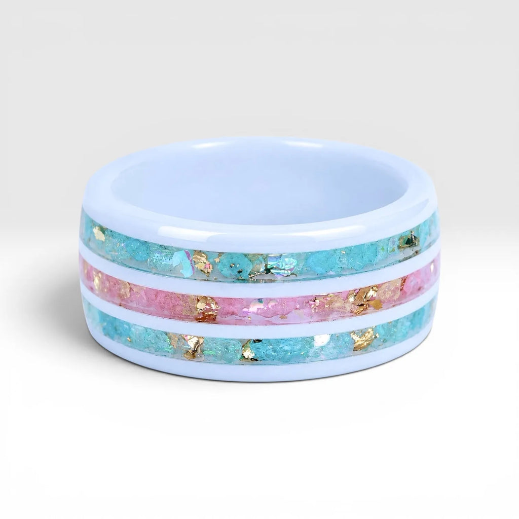 Bloomstripe white ceramic ring featuring three floral inlay channels with real flower petals, iridescent accents, and gold leaf details.