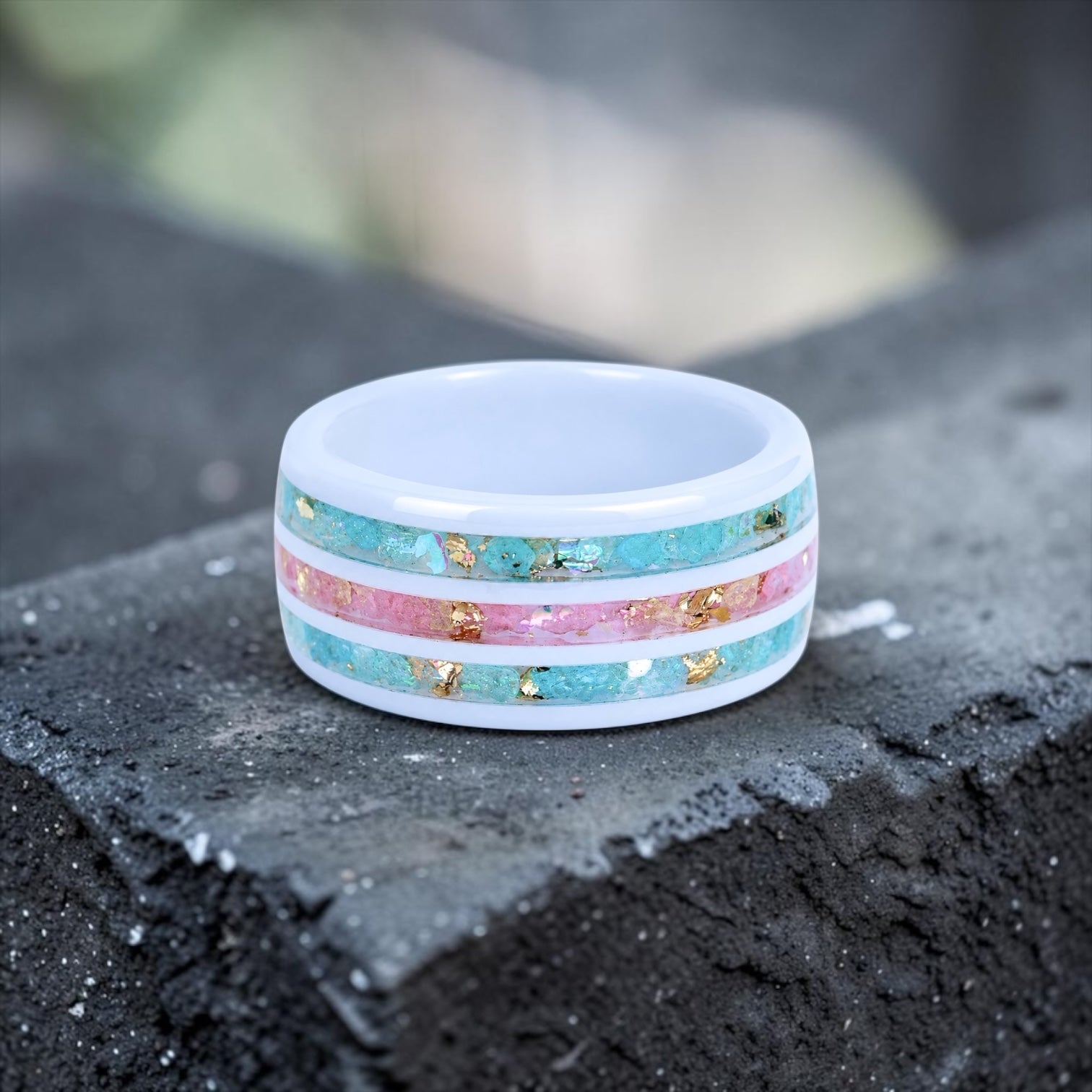 Bloomstripe white ceramic ring featuring three floral inlay channels with real flower petals, iridescent accents, and gold leaf details.