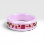 Blosselle pink ceramic ring featuring real pressed flowers preserved in a handcrafted floral inlay.