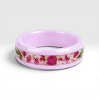 Blosselle pink ceramic ring featuring real pressed flowers preserved in a handcrafted floral inlay.