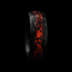 Cataclysm black titanium ring featuring meteorite fragments, blue dinosaur bone, lava stone inlay, and red glow accents with a rugged distressed finish.