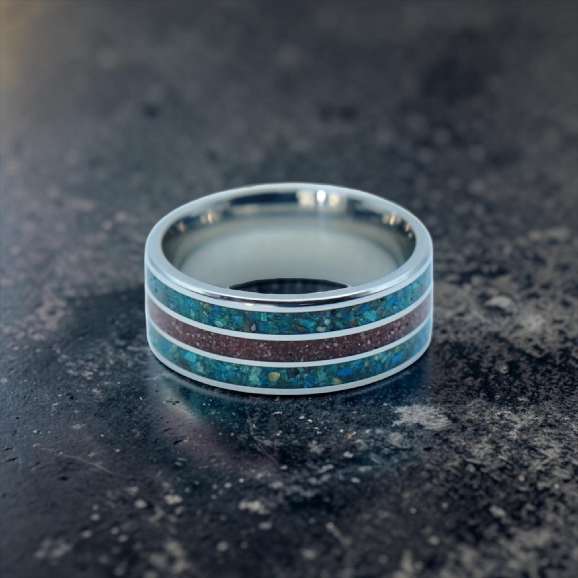 Tungsten ring with chrysocolla and cinnabar inlay featuring bold blue and red tones, polished band with textured design