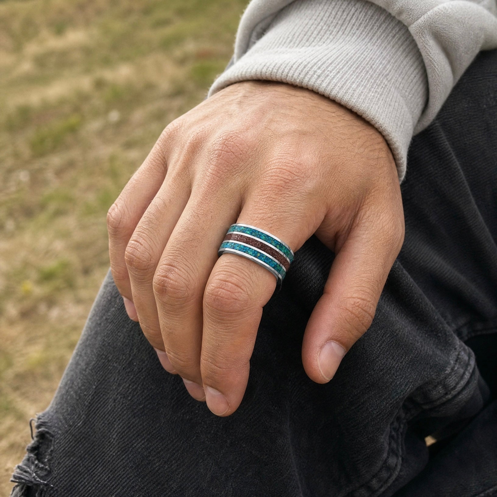 Tungsten ring with chrysocolla and cinnabar inlay featuring bold blue and red tones, polished band with textured design