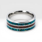 Tungsten ring with chrysocolla and cinnabar inlay featuring bold blue and red tones, polished band with textured design