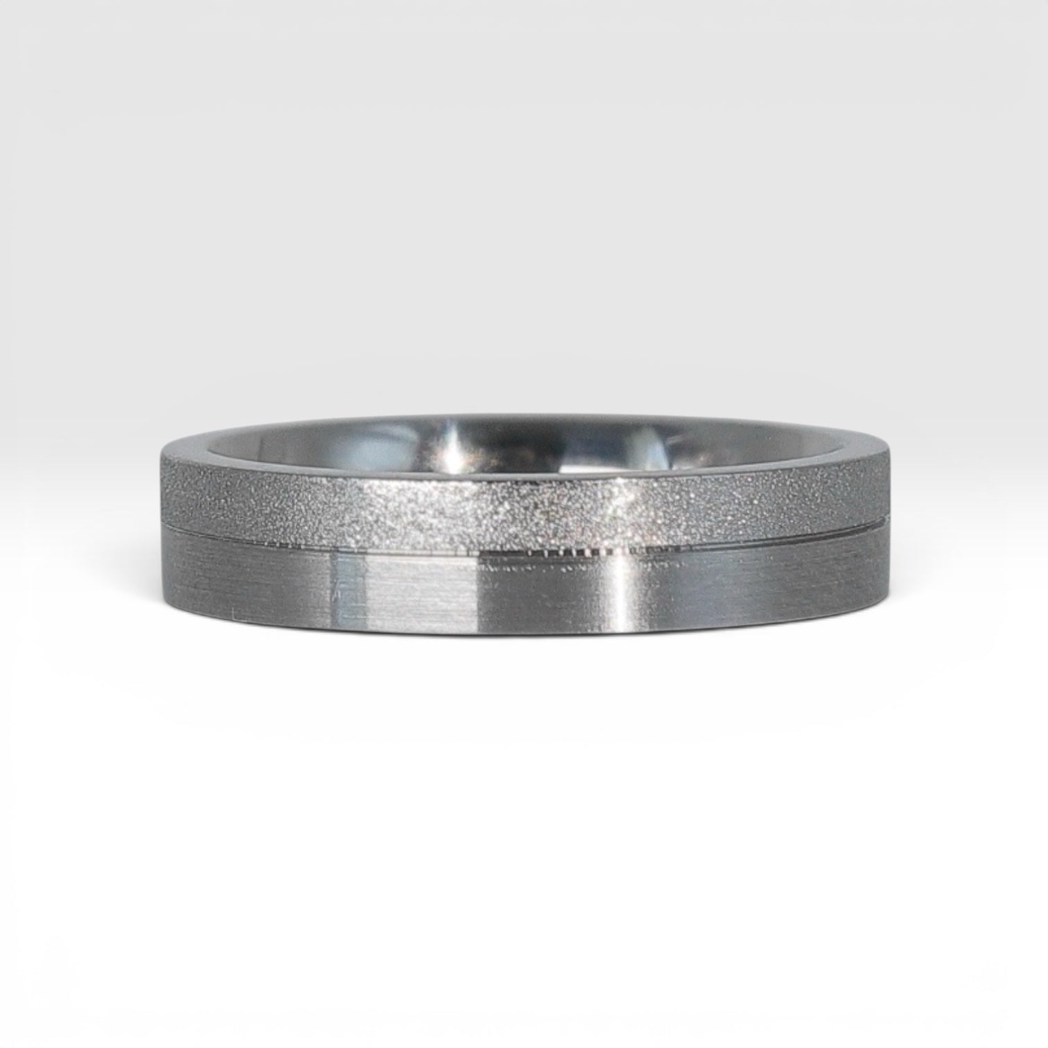 4mm titanium women's wedding band featuring two-tone frosted finish and satin finish with architectural groove detail