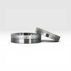 Matching two-tone wedding band set, 6mm his and 4mm hers, with frosted diamond burr top half and satin lower half separated by a precision groove, handcrafted in Utah