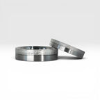 Matching two-tone wedding band set, 6mm his and 4mm hers, with frosted diamond burr top half and satin lower half separated by a precision groove, handcrafted in Utah