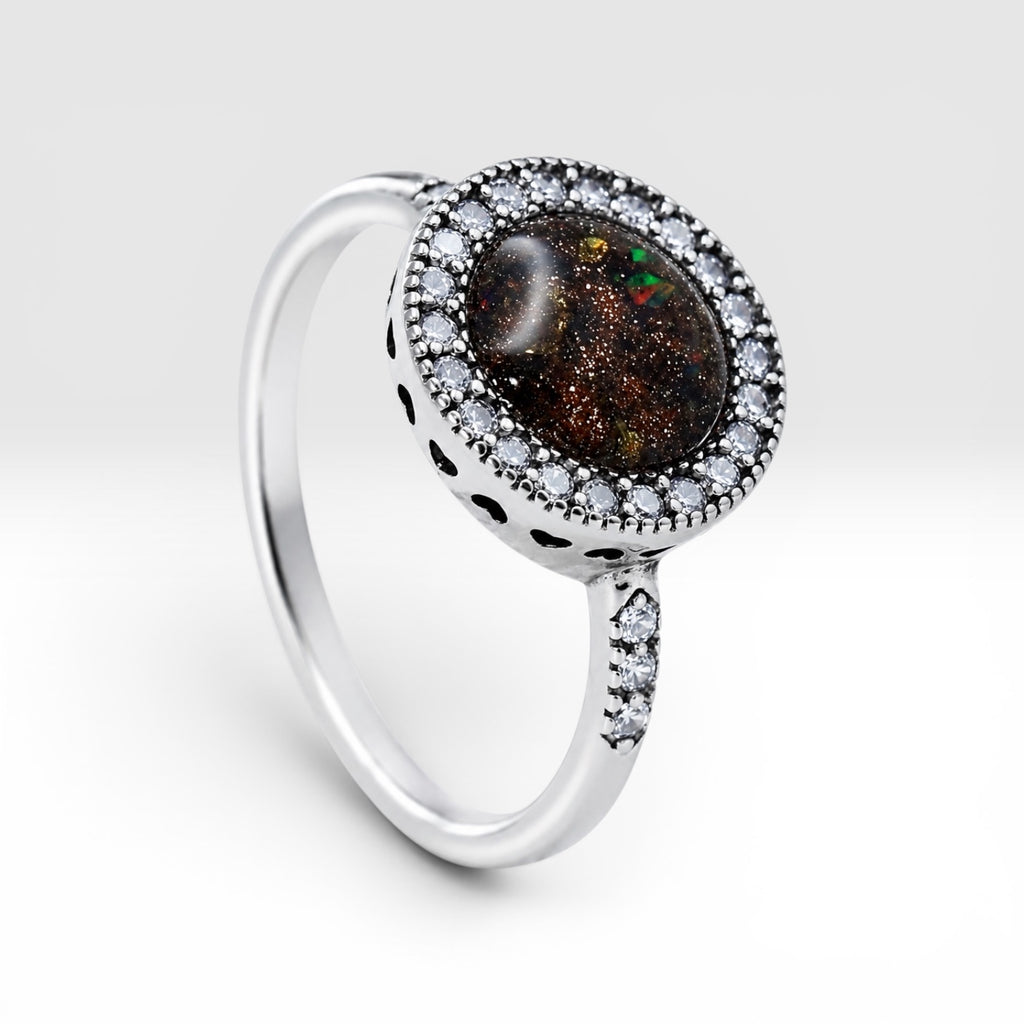 Resin gemstone ring with goldstone sparkle and lava opal shimmer set in sterling silver halo band