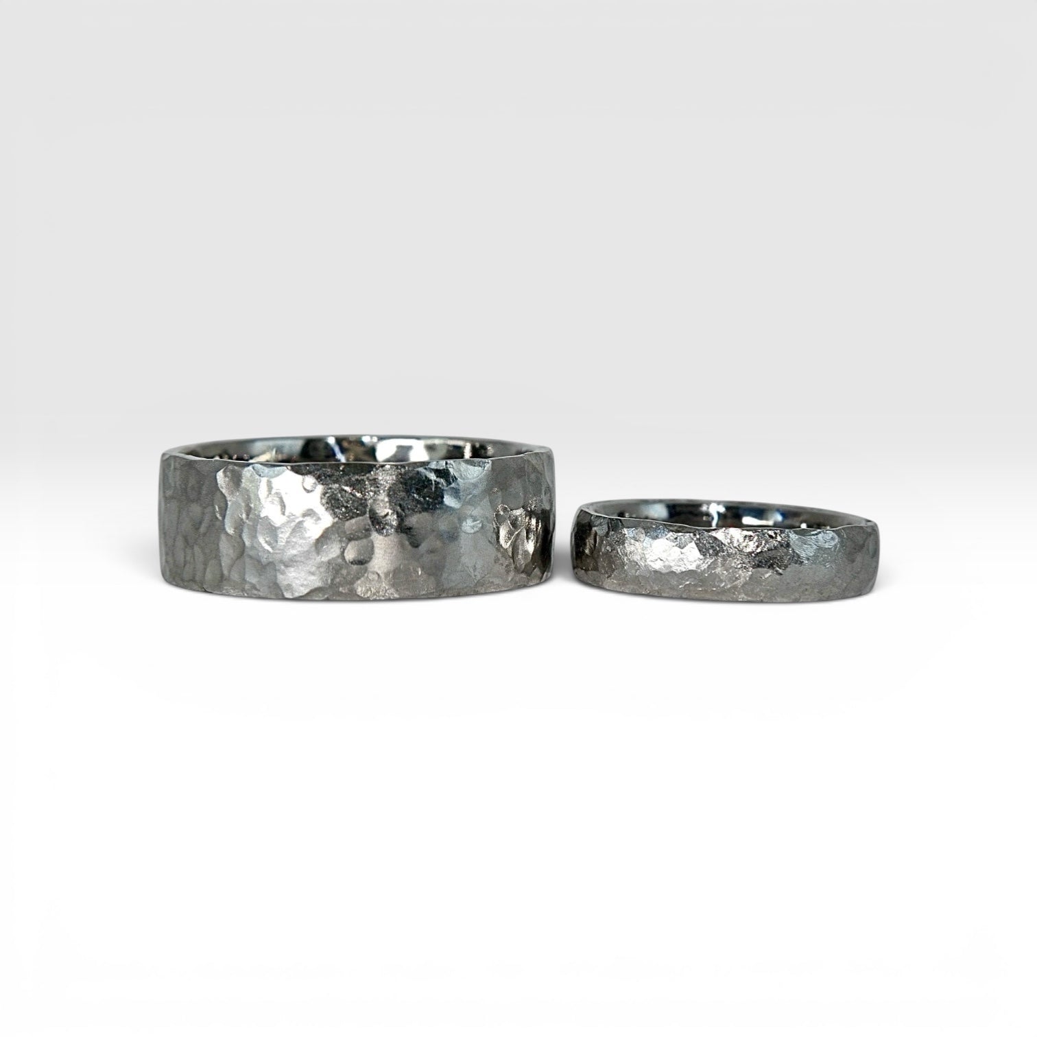 Matching hammered titanium wedding band set, 8mm domed his band and 4mm hers band with hand-forged texture finish, handcrafted in Utah