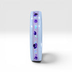Forget Me Not white ceramic ring with real pressed flowers over a glow-in-the-dark background, handcrafted memorial jewelry