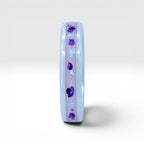 Forget Me Not white ceramic ring with real pressed flowers over a glow-in-the-dark background, handcrafted memorial jewelry