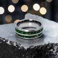 Close-up of tungsten ring with green goldstone and gold shavings showing deep green shimmer and metallic texture
