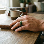 Close-up of tungsten ring with green goldstone and gold shavings showing deep green shimmer and metallic texture