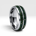 Close-up of tungsten ring with green goldstone and gold shavings showing deep green shimmer and metallic texture