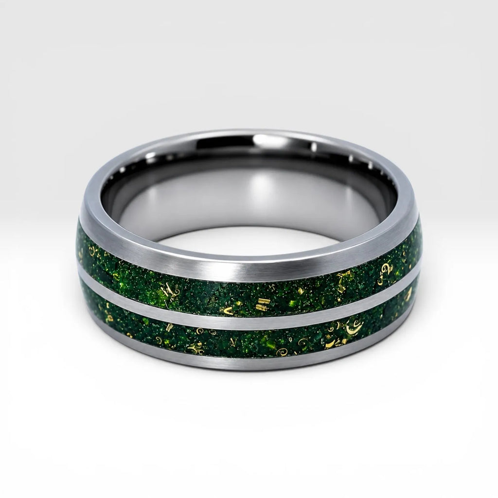 Close-up of tungsten ring with green goldstone and gold shavings showing deep green shimmer and metallic texture