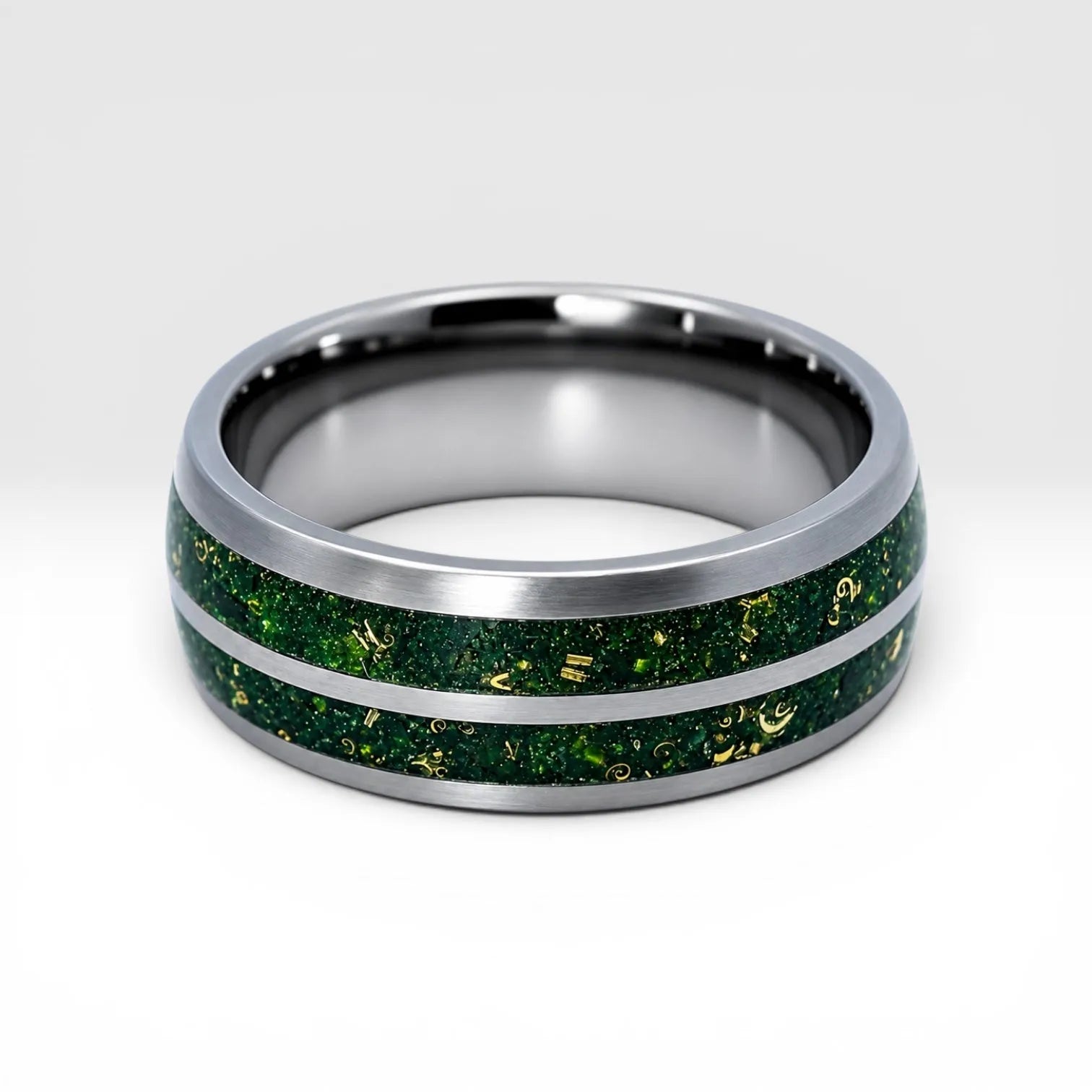 Close-up of tungsten ring with green goldstone and gold shavings showing deep green shimmer and metallic texture