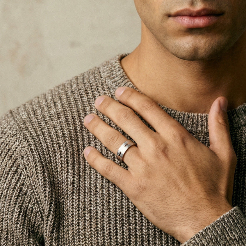 Man wearing Asterion sterling silver ring, representing modern minimalist men’s rings collection with everyday wear style