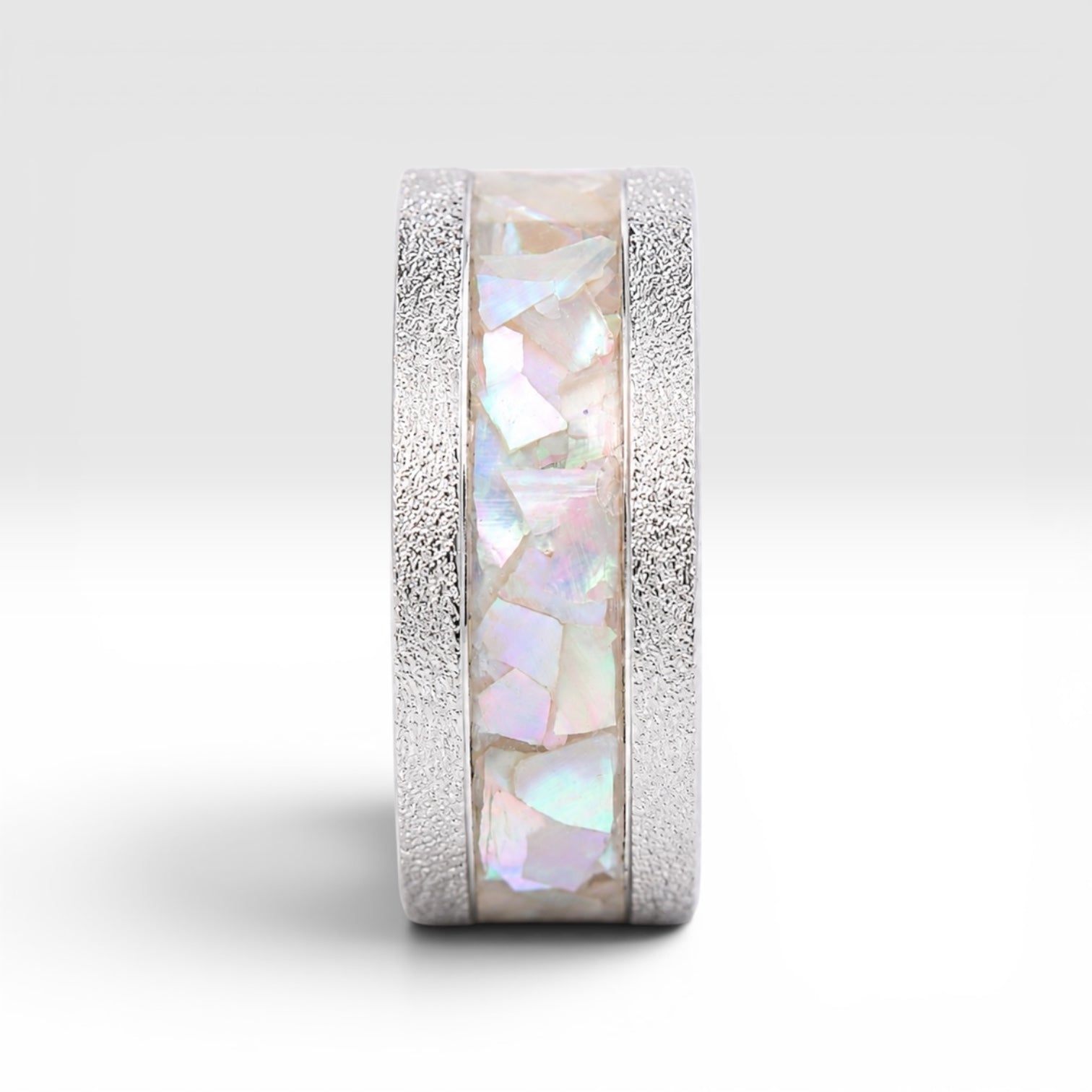 Close-up detail of genuine mother of pearl inlay displaying natural iridescence within the Moonveil cobalt ring.