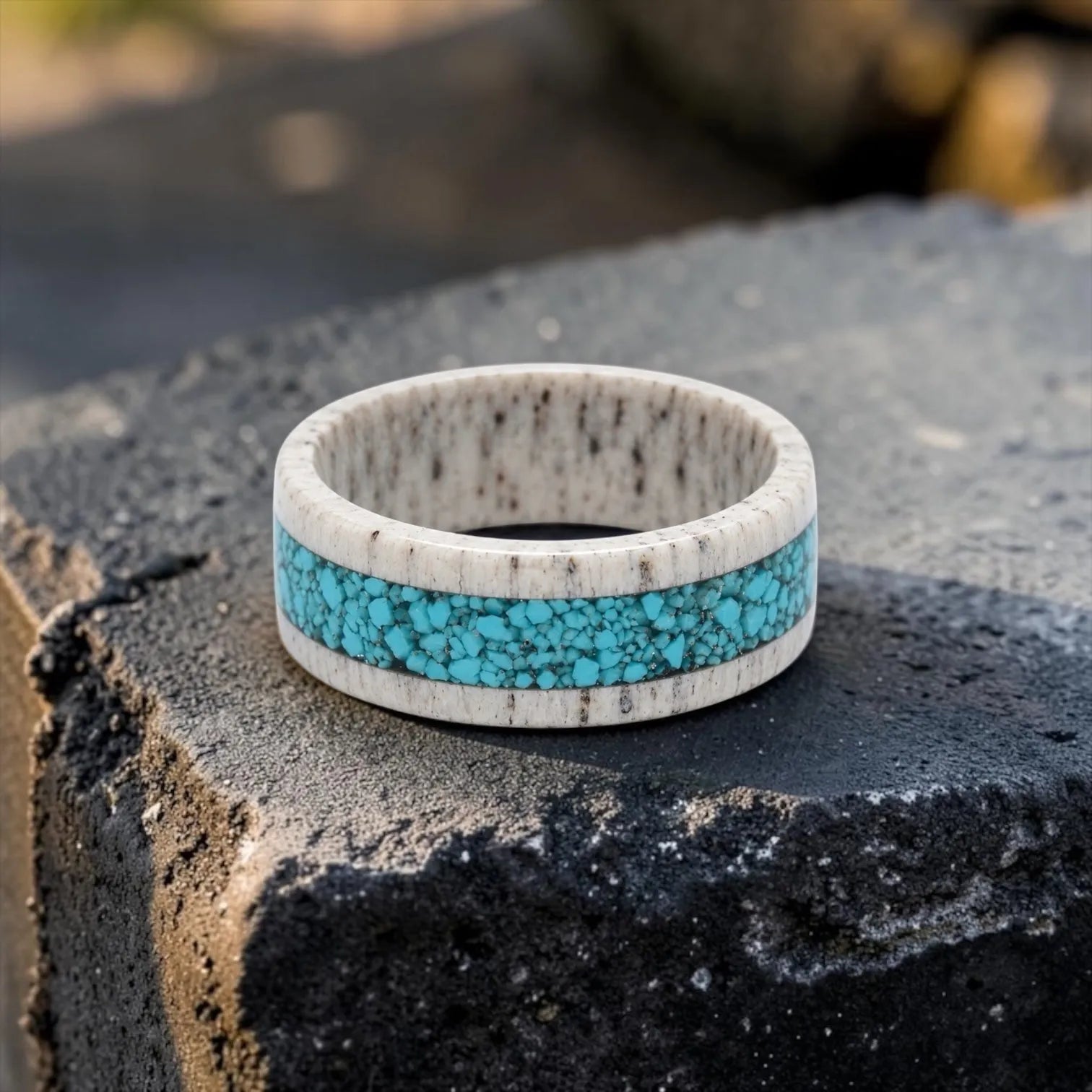 Close-up of deer antler ring with crushed turquoise inlay showing natural texture and stone detail