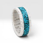 Close-up of deer antler ring with crushed turquoise inlay showing natural texture and stone detail