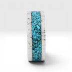Close-up of deer antler ring with crushed turquoise inlay showing natural texture and stone detail