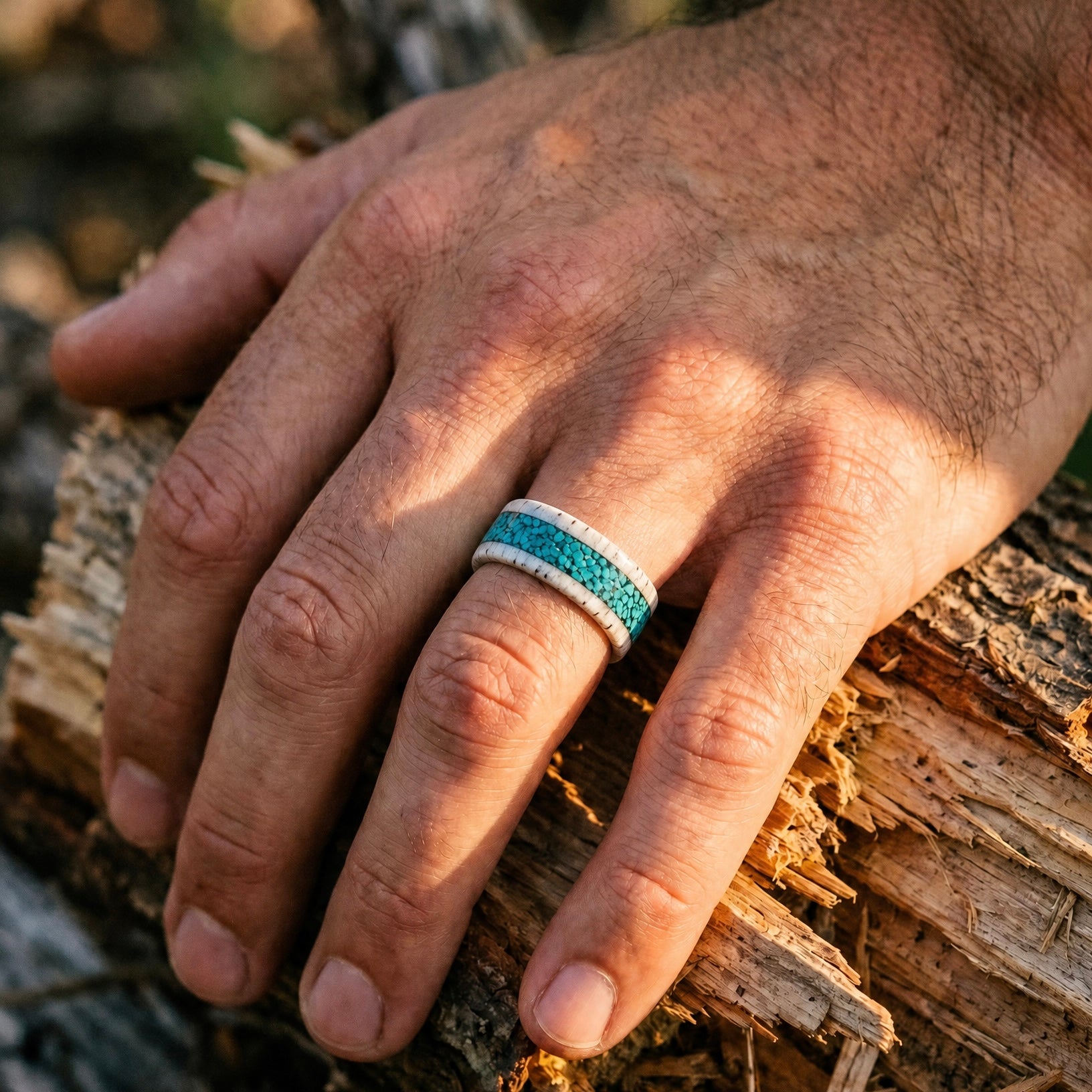 Close-up of deer antler ring with crushed turquoise inlay showing natural texture and stone detail