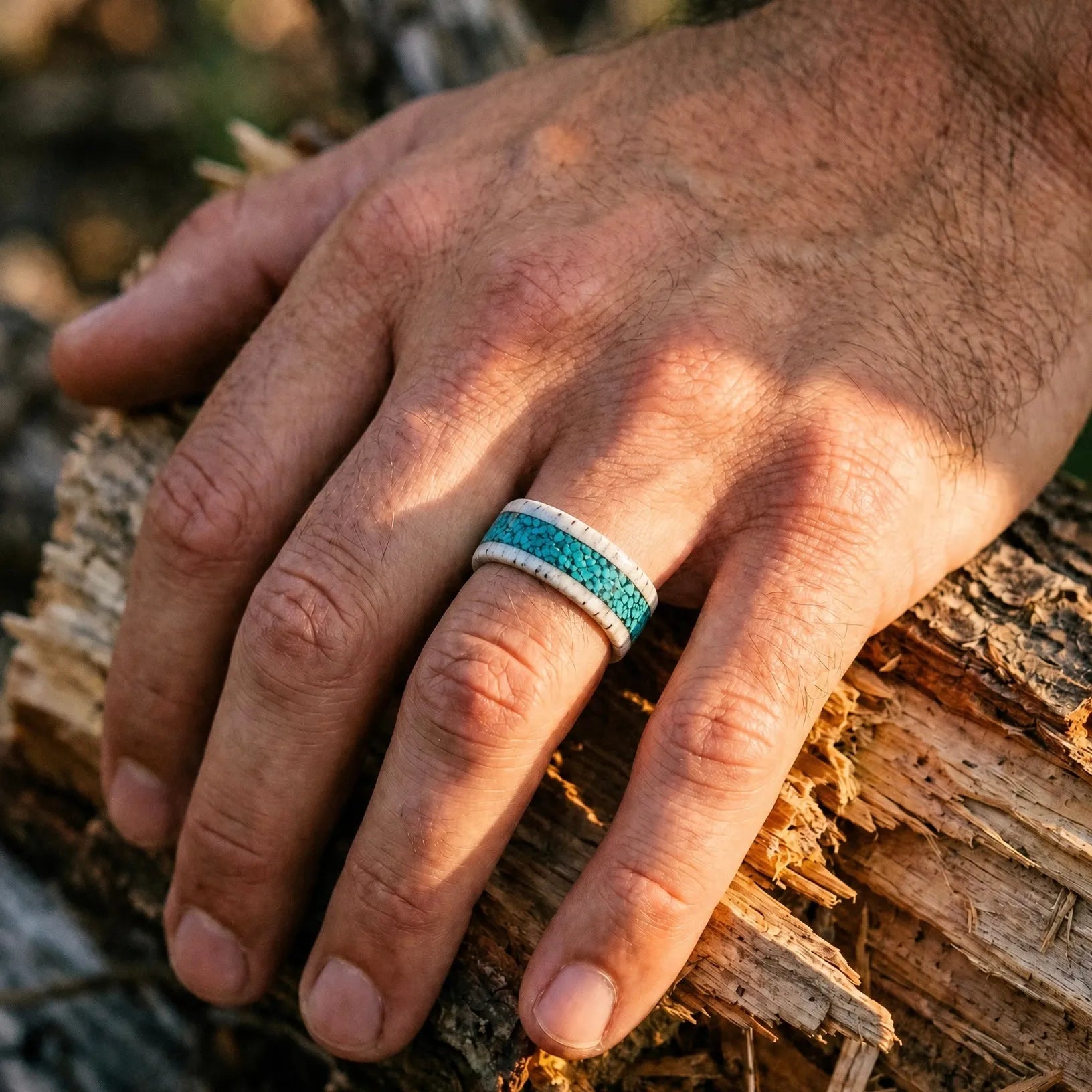 Close-up of deer antler ring with crushed turquoise inlay showing natural texture and stone detail