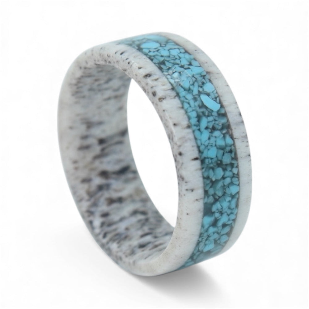 Close-up of deer antler ring with crushed turquoise inlay showing natural texture and stone detail