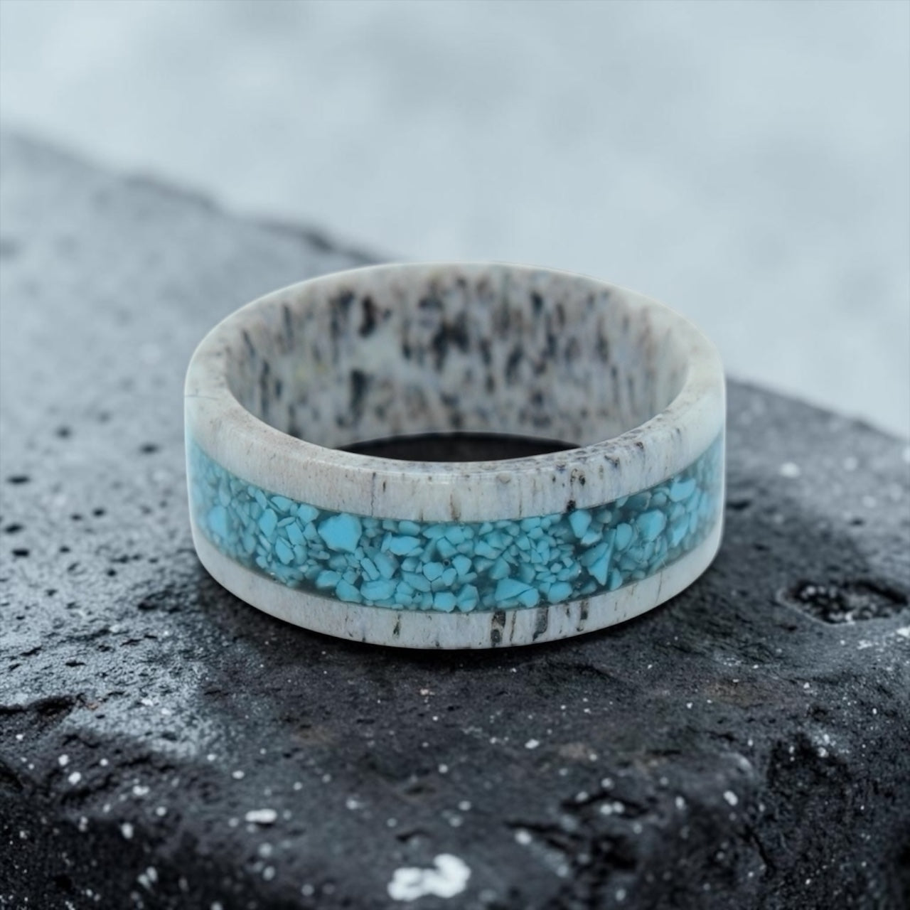 Close-up of deer antler ring with crushed turquoise inlay showing natural texture and stone detail