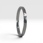 Side view of Órbita Roca hammered stacking ring showing raw textured surface and slim 2mm profile