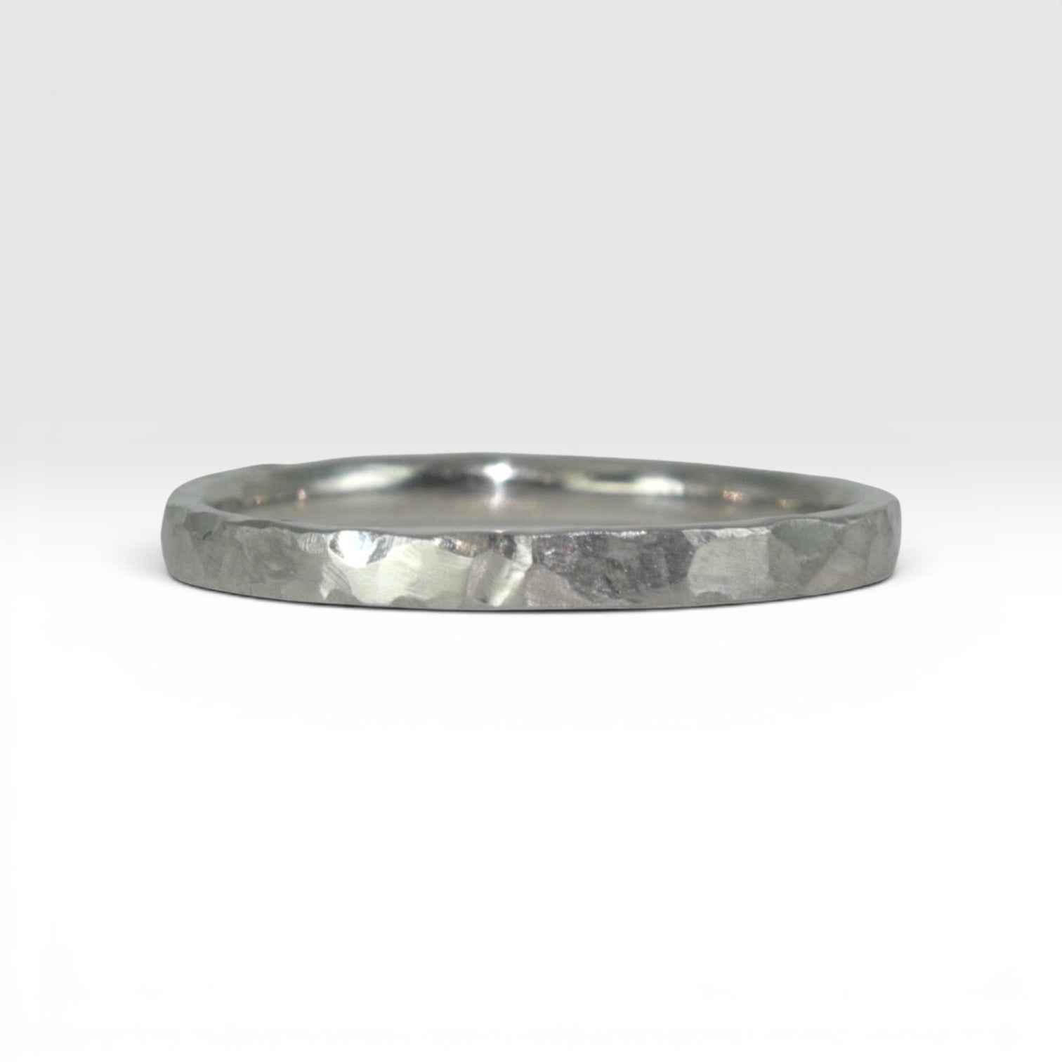 Órbita Roca 2mm hammered titanium stackable ring, flat profile with hand-textured surface, polished interior, made in Utah