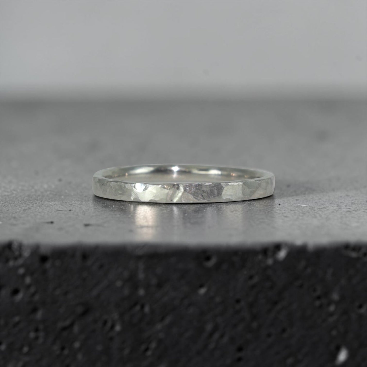 Órbita Roca 2mm hammered titanium stackable ring, flat profile with hand-textured surface, polished interior, made in Utah
